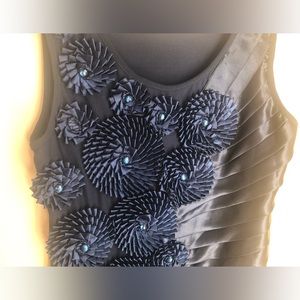 Gorgeous short dress with flower details and satin plaits. Unique design.